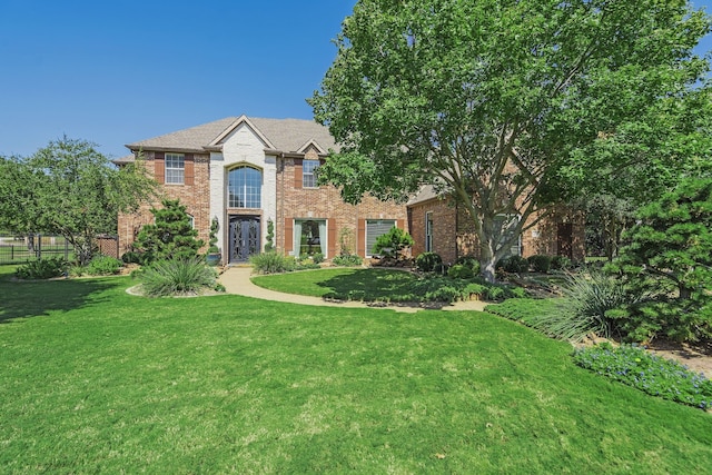 view of front facade featuring a front lawn and brick siding