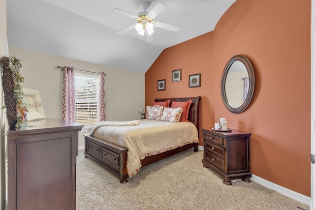 bedroom featuring light colored carpet, baseboards, lofted ceiling, and a ceiling fan