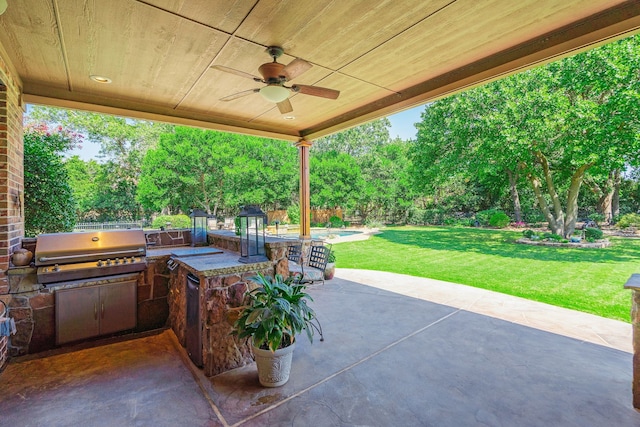 view of patio / terrace with a ceiling fan, a fenced backyard, a grill, an outdoor pool, and an outdoor kitchen