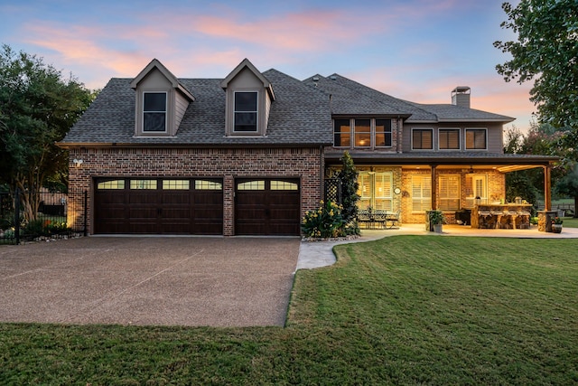 view of front facade with an attached garage, brick siding, roof with shingles, and a lawn