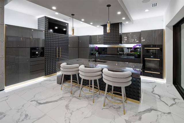 kitchen with marble finish floor, modern cabinets, dobule oven black, gray cabinets, and a sink