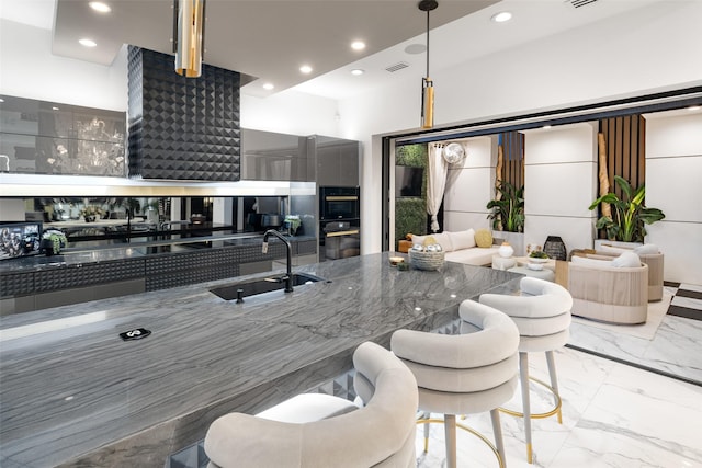 kitchen with a sink, visible vents, marble finish floor, and recessed lighting