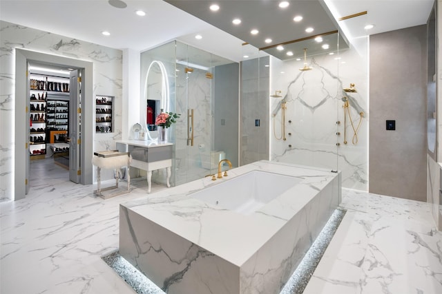 full bath with vanity, stone wall, a marble finish shower, recessed lighting, and marble finish floor