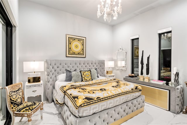 bedroom with marble finish floor and an inviting chandelier