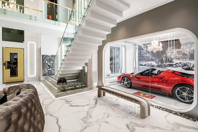 interior space with marble finish floor and a towering ceiling