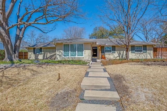 view of front facade featuring brick siding and fence