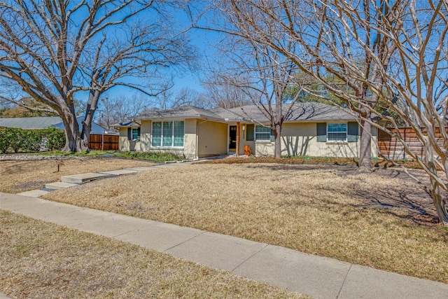 single story home featuring a front lawn and fence