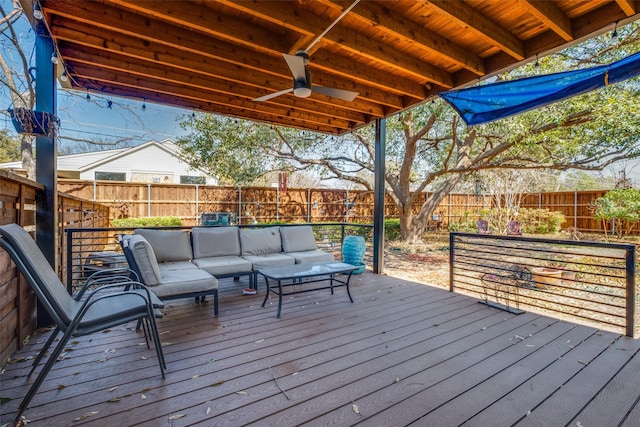 deck with a ceiling fan, a fenced backyard, and an outdoor hangout area