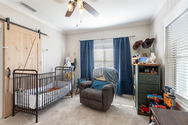 bedroom featuring visible vents, a barn door, carpet flooring, and crown molding