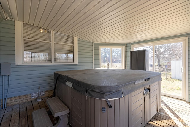 wooden terrace featuring fence and a hot tub