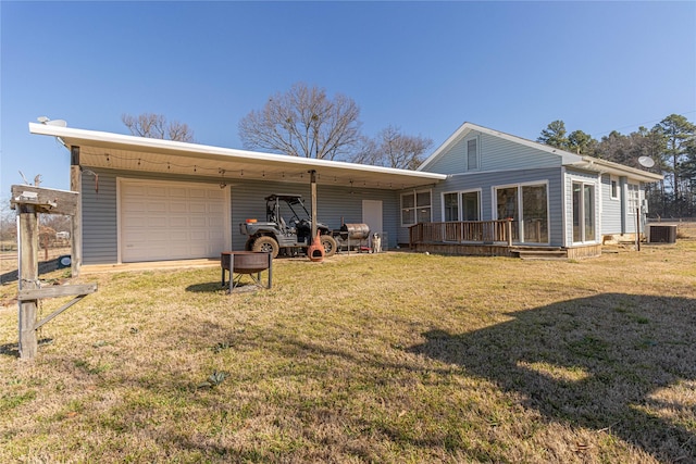 rear view of property with a lawn and driveway