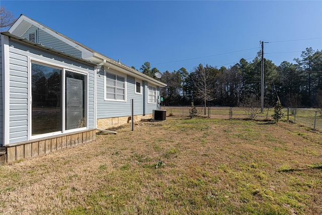 view of yard featuring cooling unit and fence