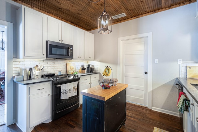 kitchen with visible vents, backsplash, white cabinets, gas stove, and wood counters