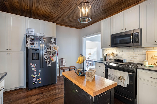 kitchen featuring butcher block countertops, dark wood finished floors, stainless steel appliances, white cabinets, and decorative backsplash