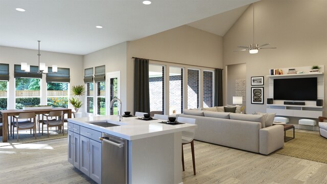 kitchen with light countertops, light wood-style floors, open floor plan, and a sink