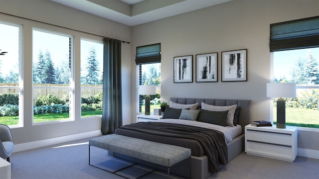 bedroom with multiple windows, light colored carpet, and baseboards