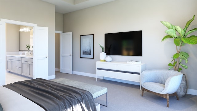 bedroom featuring light carpet, ensuite bath, and baseboards