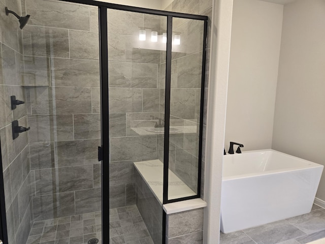 full bathroom featuring a shower stall and a freestanding tub