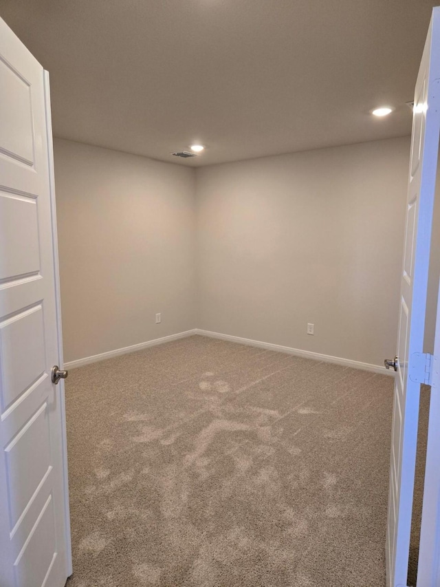 spare room featuring recessed lighting, carpet, and baseboards