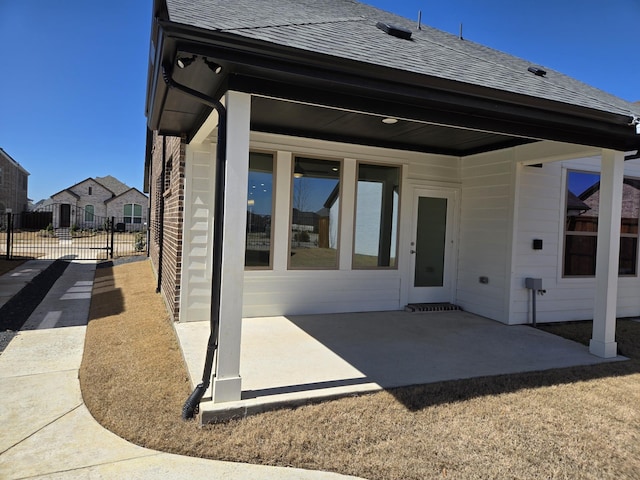 view of patio featuring a gate and fence