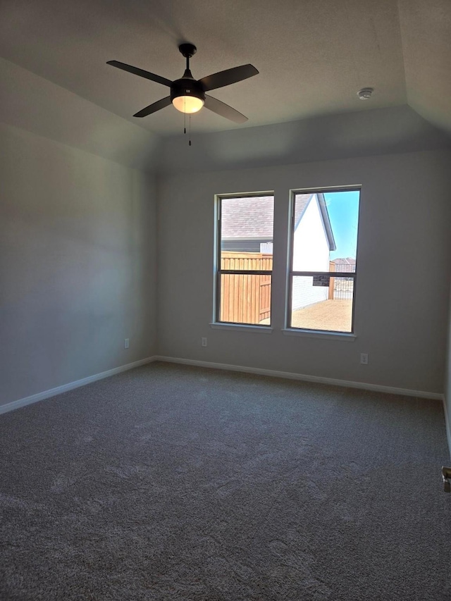 empty room with baseboards, carpet floors, and lofted ceiling