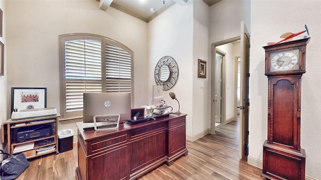 home office featuring ornamental molding, baseboards, and wood finished floors