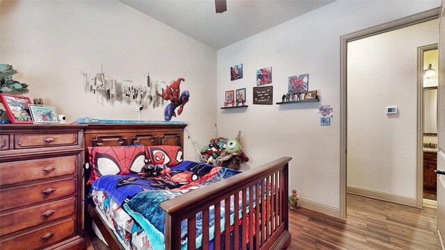 bedroom featuring a ceiling fan, baseboards, and wood finished floors