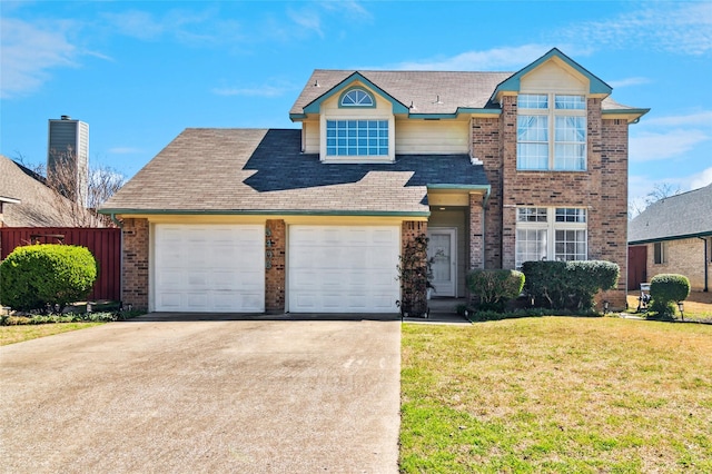 view of front of home featuring a front yard, fence, concrete driveway, a garage, and brick siding