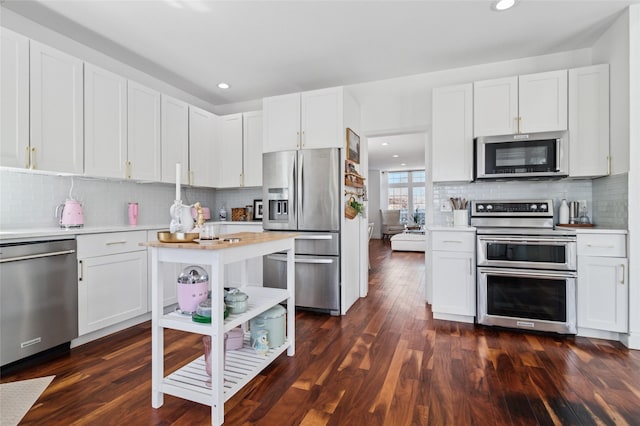 kitchen featuring light countertops, white cabinets, dark wood-style flooring, and appliances with stainless steel finishes