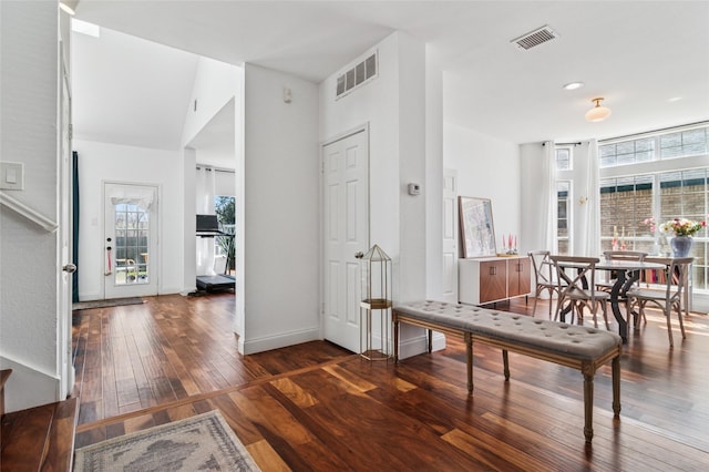 entryway with hardwood / wood-style floors, visible vents, and a wealth of natural light