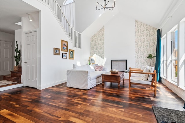 living area featuring an inviting chandelier, wood finished floors, and stairs