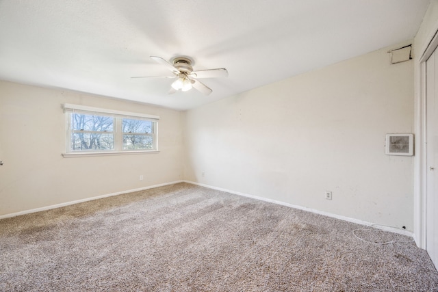 empty room featuring carpet flooring, baseboards, and a ceiling fan