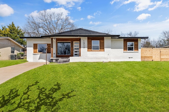 view of front of property with a front yard, fence, and brick siding