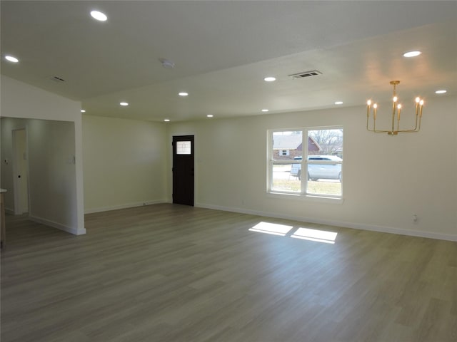 spare room featuring recessed lighting, visible vents, baseboards, and wood finished floors