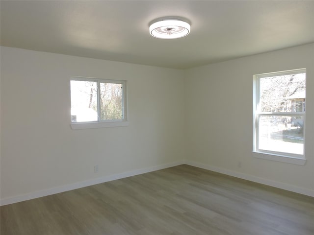 empty room featuring baseboards and wood finished floors