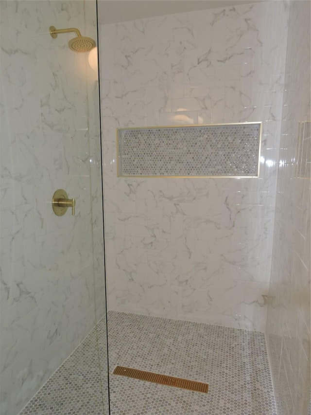 full bath featuring a marble finish shower