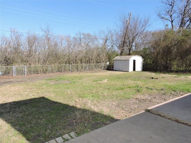 view of yard featuring a fenced backyard, a storage shed, and an outdoor structure