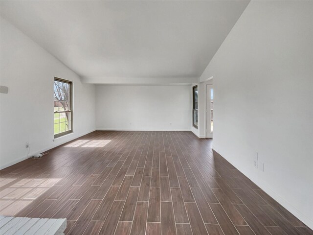 unfurnished living room with visible vents, a fireplace, lofted ceiling, and wood finish floors