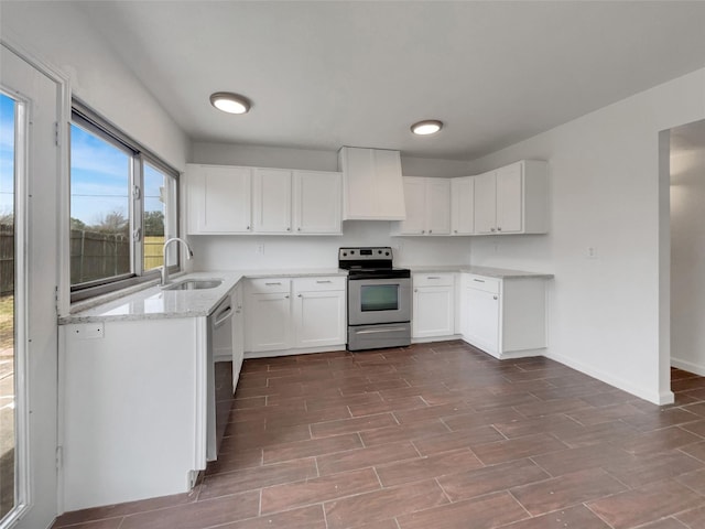 kitchen with wood finish floors, a sink, stainless steel appliances, custom range hood, and white cabinets