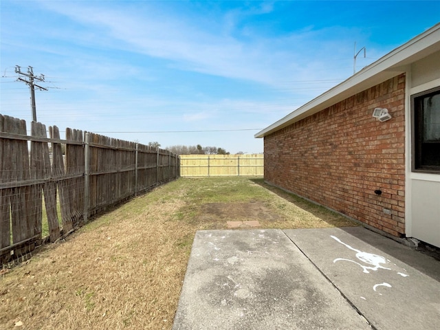 view of yard with a patio area and a fenced backyard