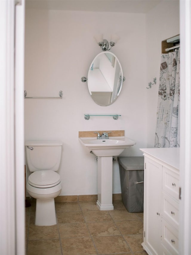 full bath featuring tile patterned floors, baseboards, and toilet