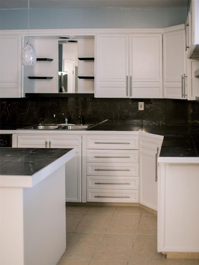 kitchen with dark countertops, white cabinets, tasteful backsplash, and open shelves