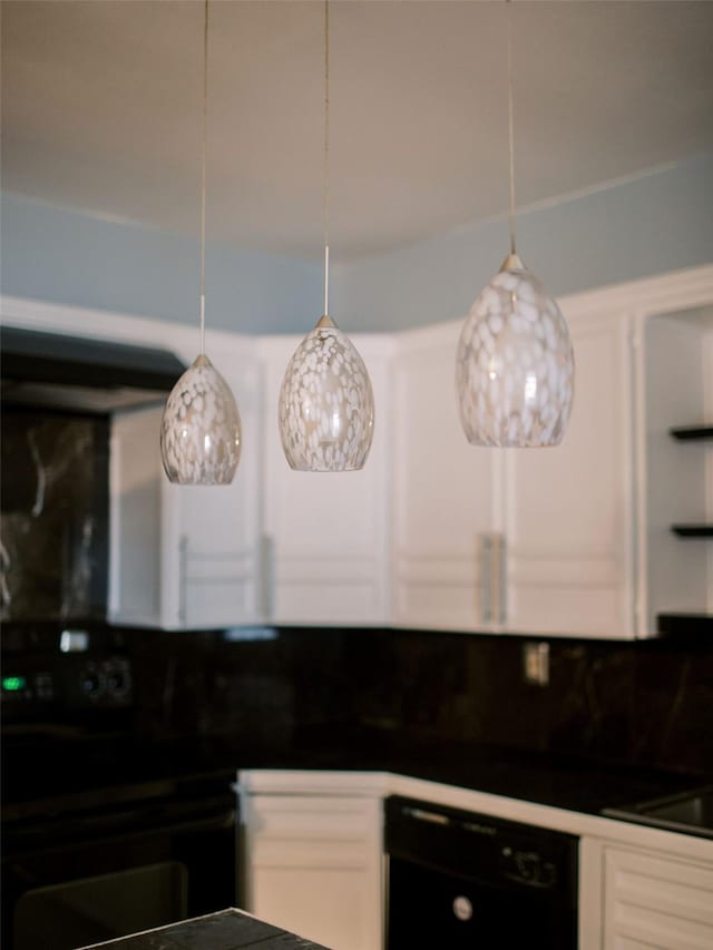 kitchen with dark countertops, white cabinetry, and black appliances