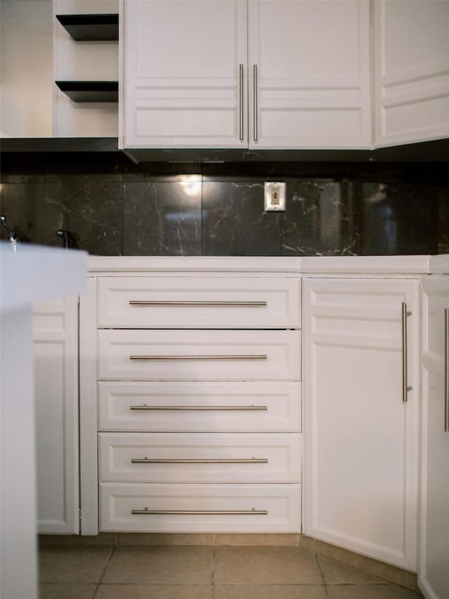 kitchen featuring tile patterned floors, white cabinets, tasteful backsplash, and open shelves