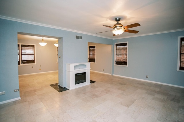 interior space with a glass covered fireplace, baseboards, and visible vents