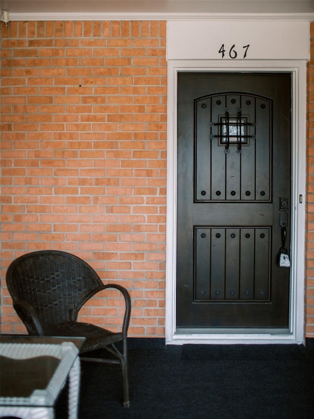 view of exterior entry with brick siding