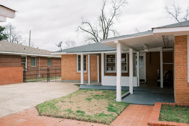 view of front of house with brick siding and a porch