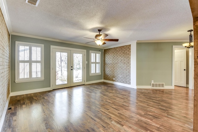 spare room featuring visible vents, wood finished floors, and french doors