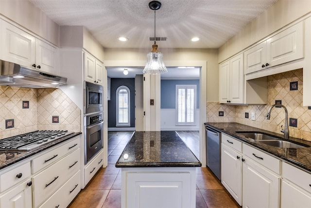 kitchen featuring a kitchen island, a sink, stainless steel appliances, under cabinet range hood, and white cabinetry