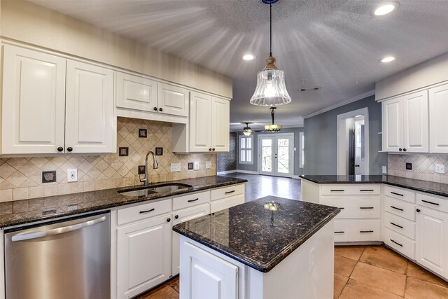 kitchen featuring under cabinet range hood, white cabinetry, a peninsula, and stainless steel appliances